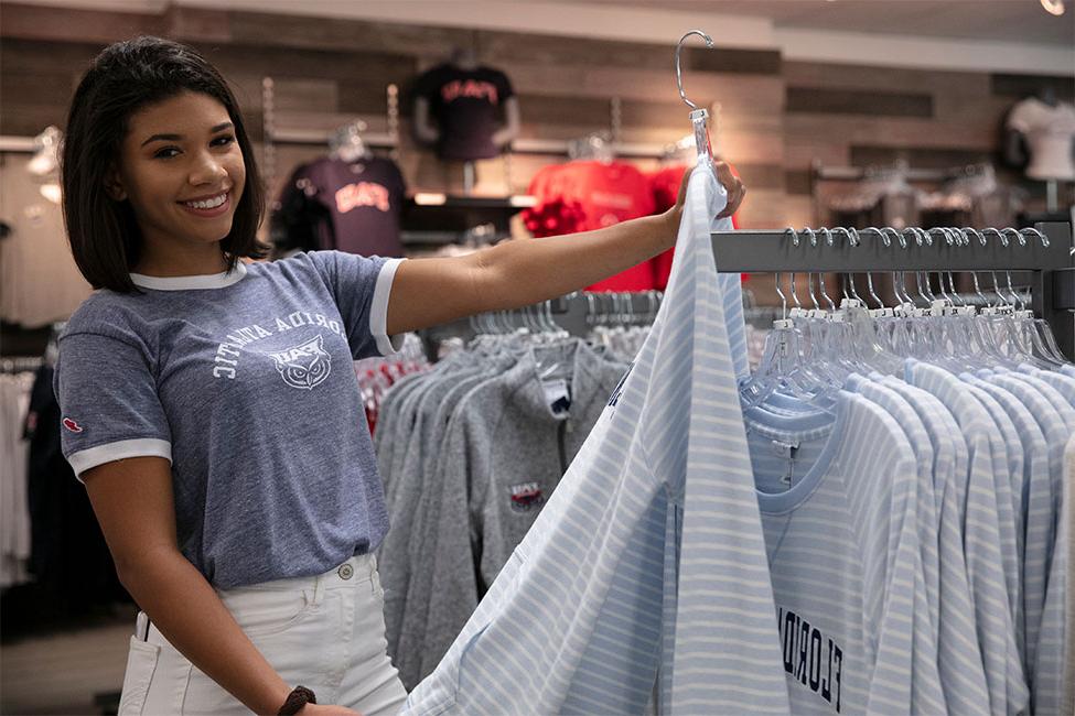 Student smiling with FAU merchandise